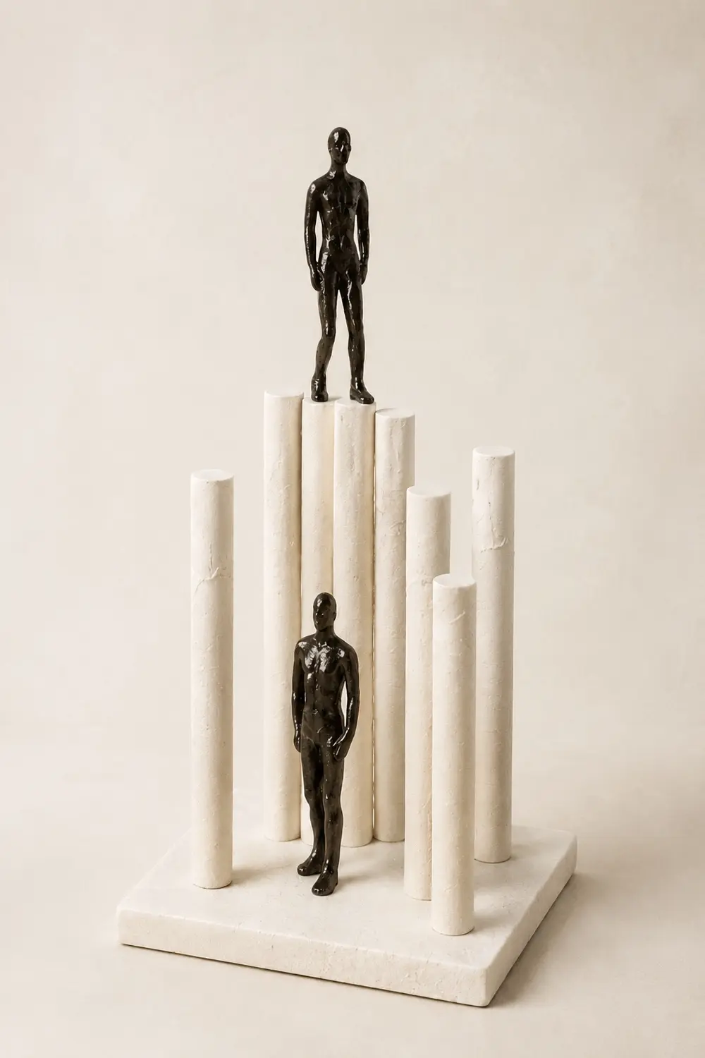 Sculptural black figures on ivory columns