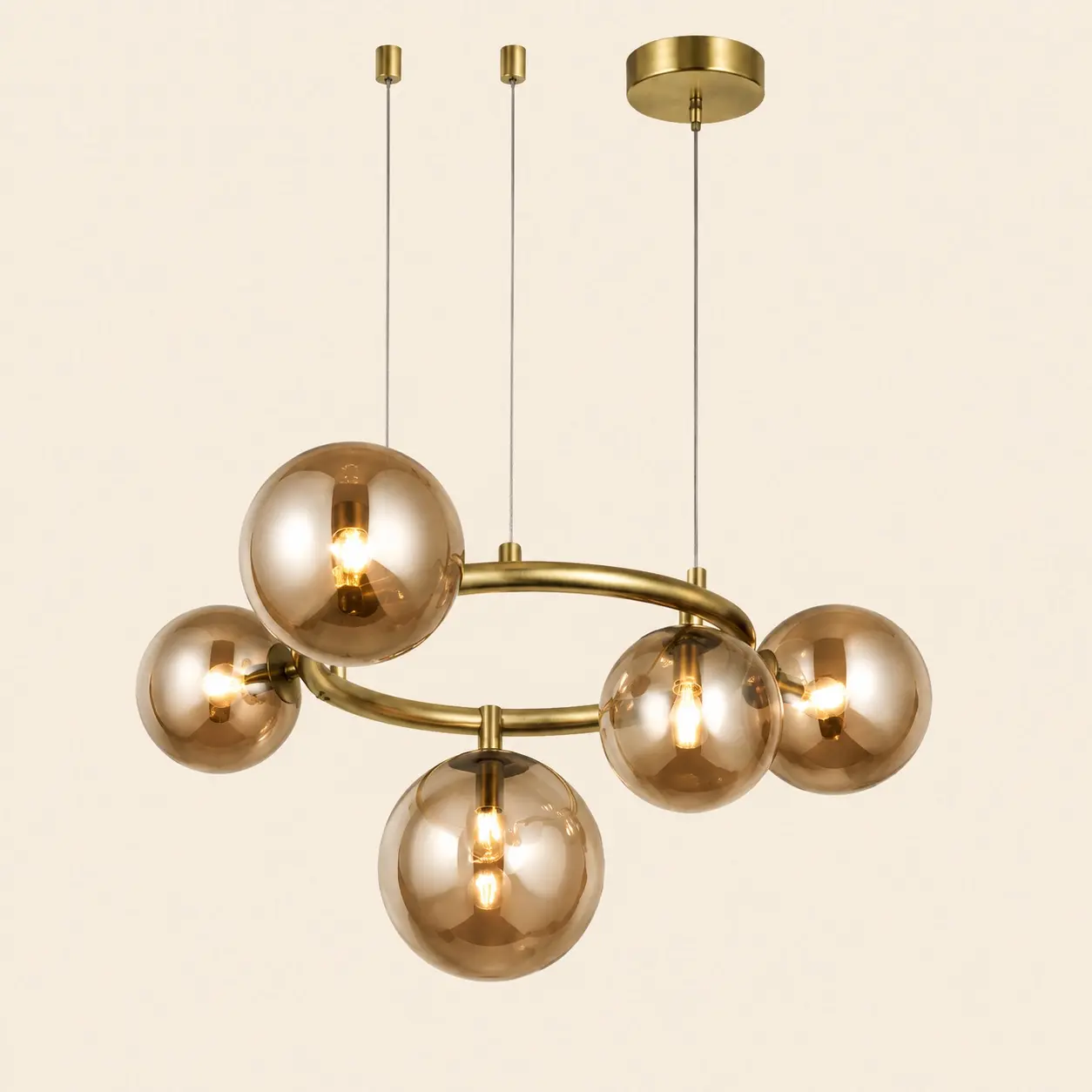 Gold circular hanging light with amber glass globes